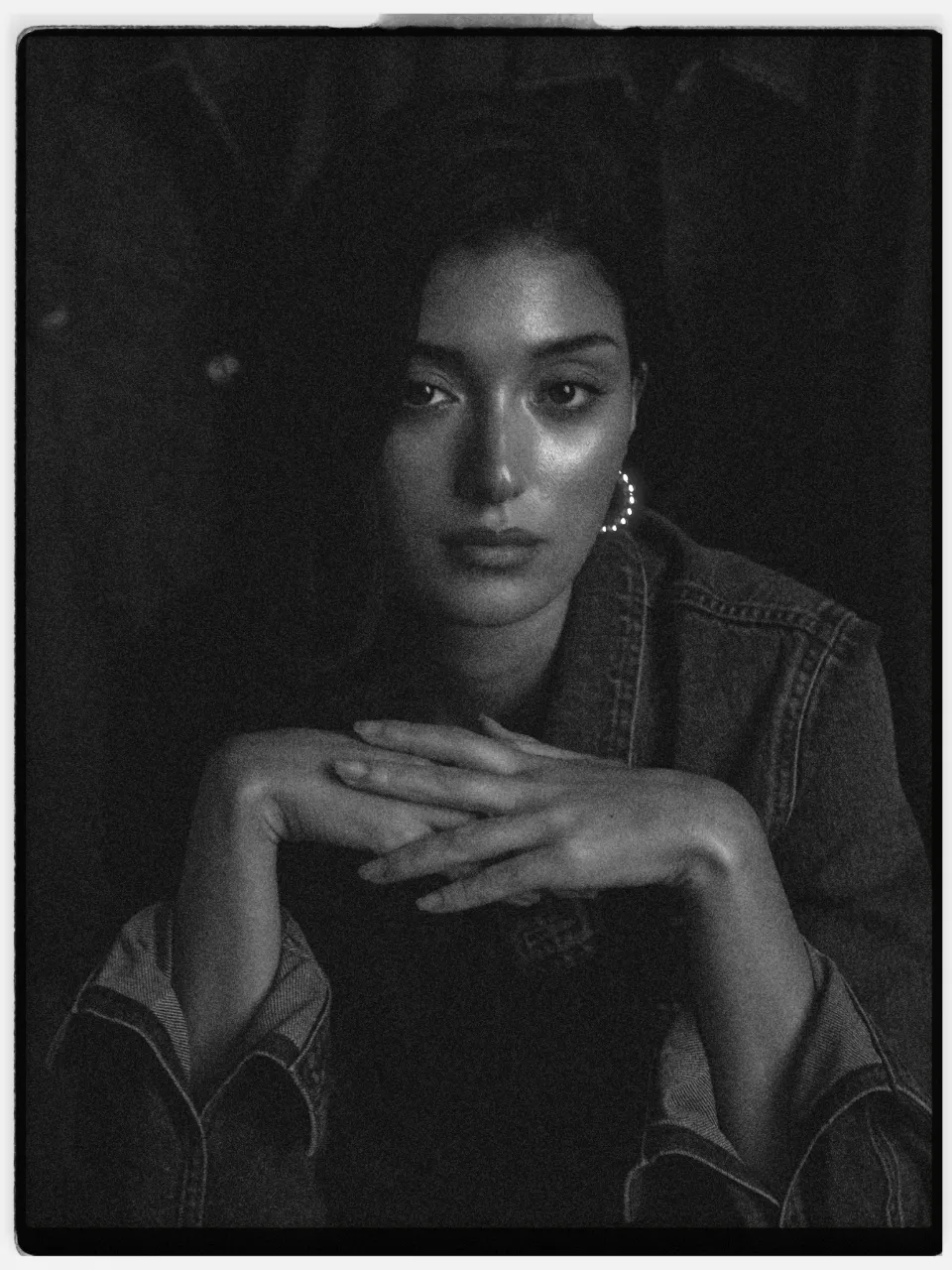 Argent 400 film stock in Chromogen, a true-black mono negative: a black and white studio portrait in a denim jacket on an instant-style print