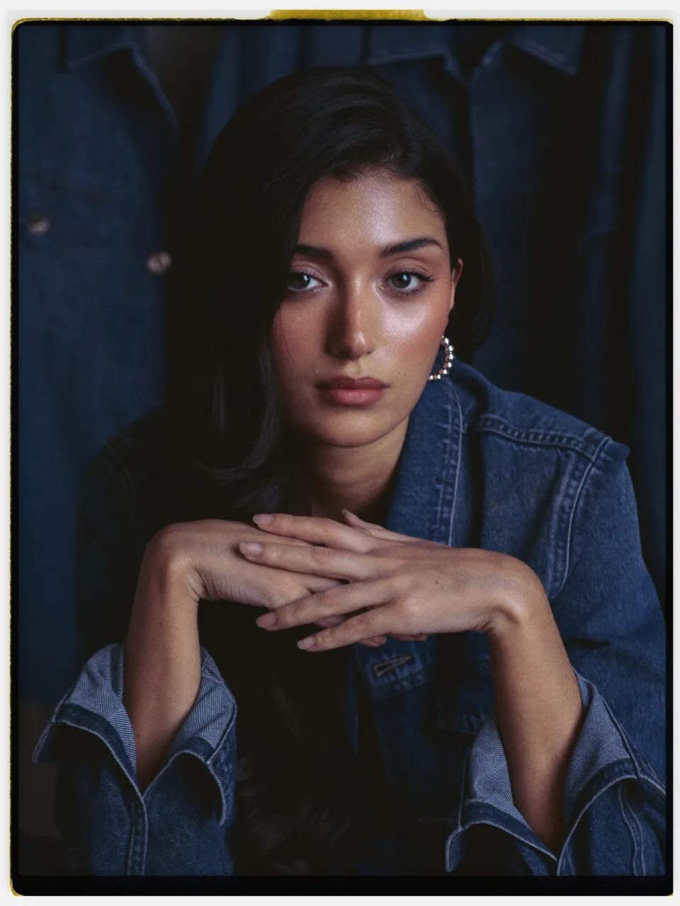 Azura 100 film stock in Chromogen, a precise cool slide film: a studio portrait in a denim jacket on an instant-style print