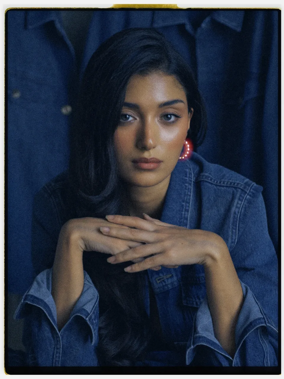 Nocta 500T film stock in Chromogen, a tungsten cine negative: a studio portrait in a denim jacket on an instant-style print