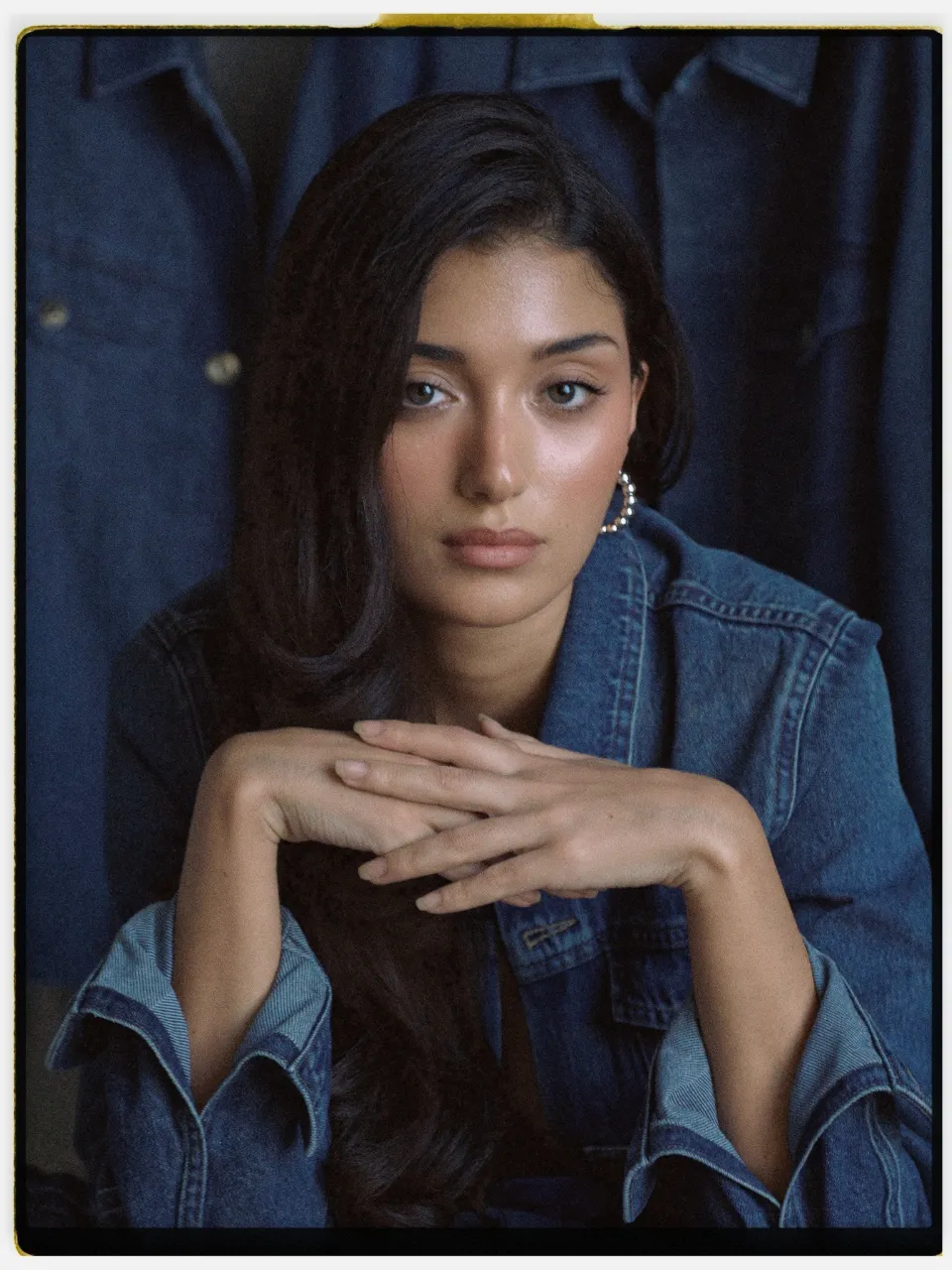 Verel 400 film stock in Chromogen, a soft pastel negative: a studio portrait in a denim jacket on an instant-style print