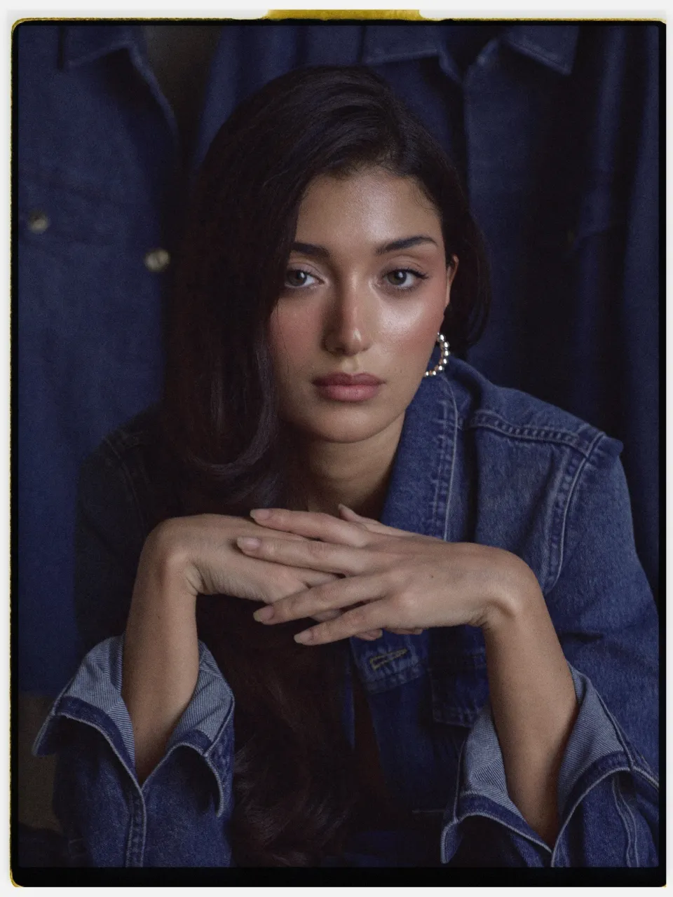 Viridia 250 film stock in Chromogen, a vivid daylight cine film: a studio portrait in a denim jacket on an instant-style print
