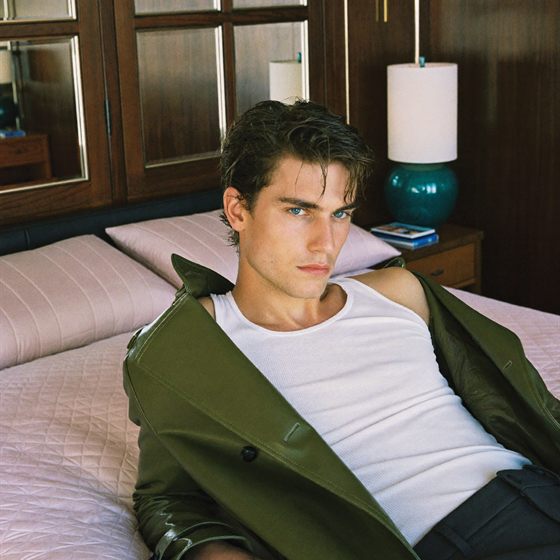 Photo in a Chromogen library: a young man in a green jacket lying on a bed