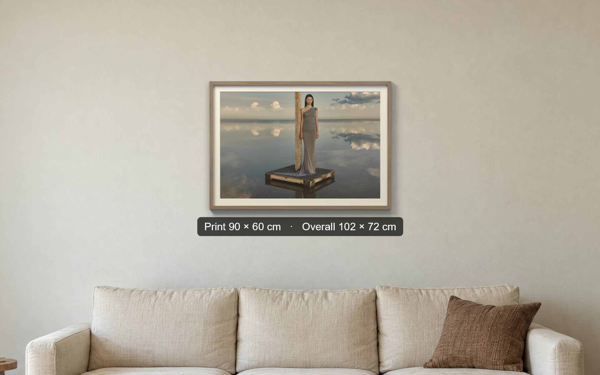 Chromogen wall mockup at true size: a 90 by 60 cm framed print above a sofa on a measured wall, with its size label