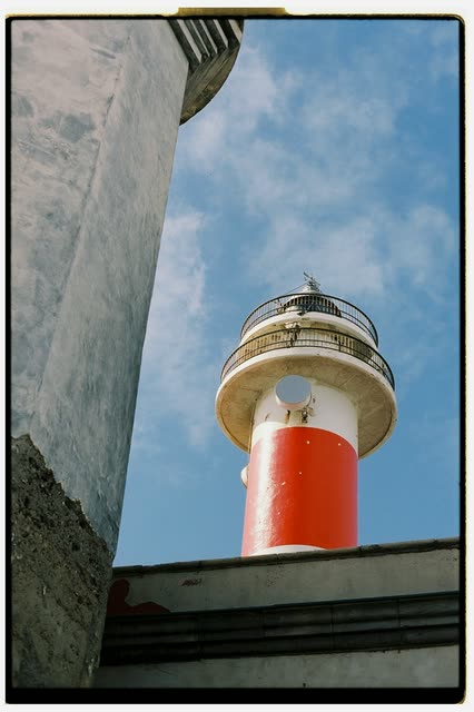 Scout photo on the moodboard: a lighthouse tower seen from below against a blue sky
