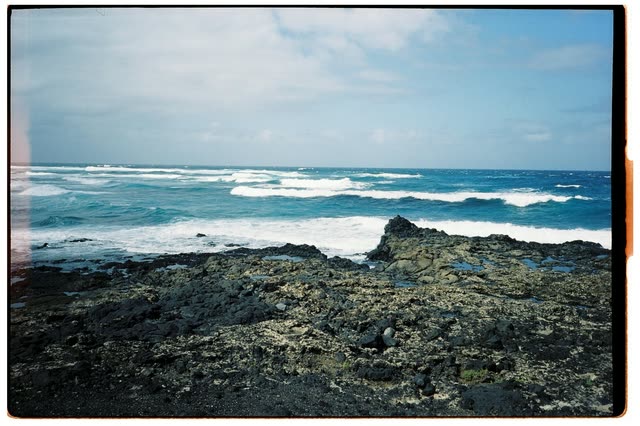 Scout photo on the moodboard: waves breaking on dark sea rocks