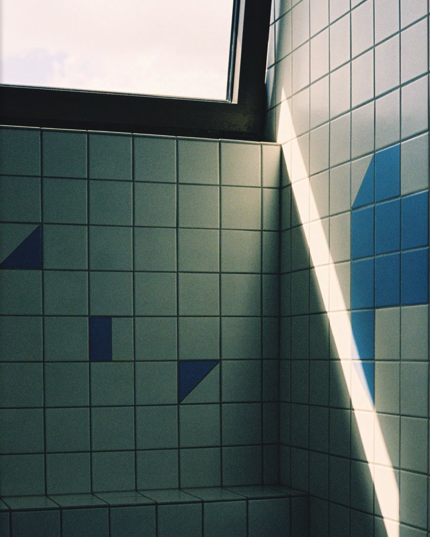 A tiled room with a window and a bright shaft of sunlight, developed as film with no border